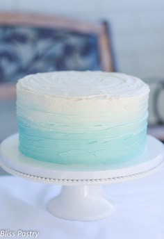 a white cake with blue and green frosting