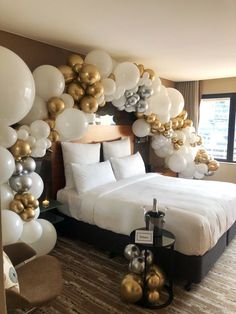 a bedroom decorated with balloons and white sheets