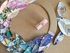 a cardboard wreath made out of different types of paper