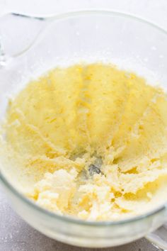 a glass bowl filled with batter on top of a table