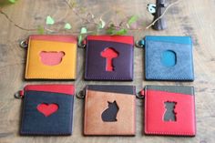 six different colored leather key fobs on a table