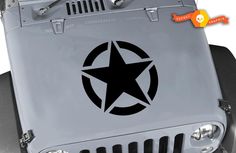 a jeep with a star painted on the front and back grills, is shown