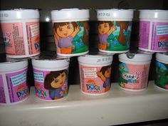 there are many ice creams on the shelf in this room, each with an image of dora