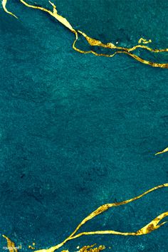 an aerial view of water and gold paint