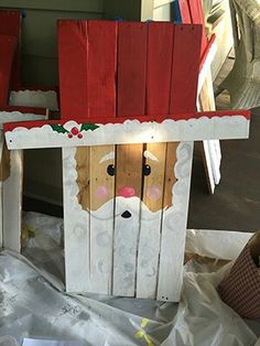 an image of a wooden house with santa clause on it's head and nose