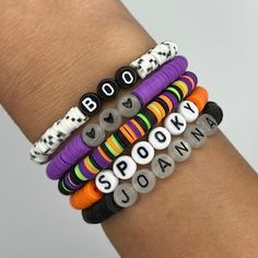 Cute Halloween Beaded Bracelets, Bracelet Ideas For Clay Beads, Clay Bead Bracelet Inspo Fall, Dark Clay Bead Bracelet, Clay Bead Bracelet Business Name Ideas, Halloween Clay Beads Ideas, Cute Beaded Bracelets Words, Preppy Halloween Bracelet, Cool Beads Bracelets