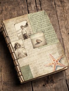 an old book with pictures and writing on the pages is sitting on a wooden table