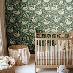 a baby crib in front of a wall with ducks and flowers on it