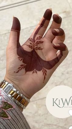 a woman's hand with hendix on it and the words kiwi written in arabic