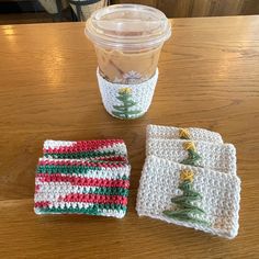 three crocheted coasters and a cup holder on a table