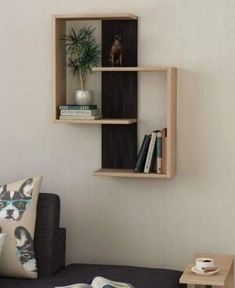 a wooden shelf with books and plants on it next to a wall mounted planter