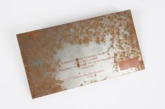 an old rusted metal business card on a white background