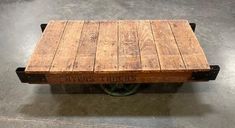 a wooden cart sitting on top of a cement floor