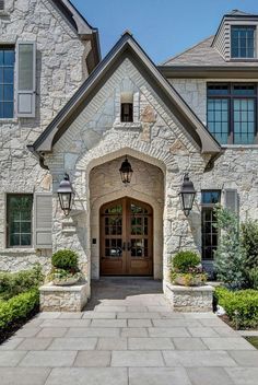 the front entrance to a large house with stone walls