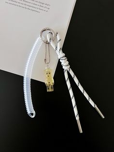 a keychain with a chain attached to it sitting on top of a piece of paper