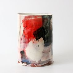 a white and red coffee cup sitting on top of a table