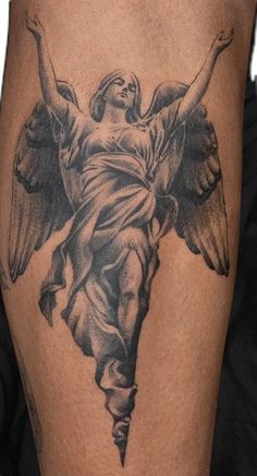 an angel tattoo on the leg of a man