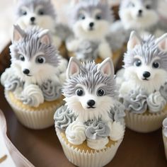 cupcakes with frosting decorated like dogs on them