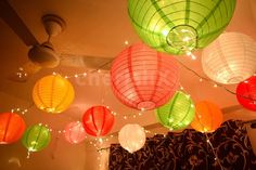 many colorful lanterns are hanging from the ceiling