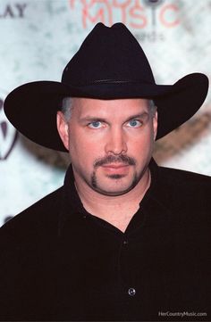 a man wearing a black cowboy hat