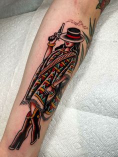 a person with a tattoo on their arm holding a knife and wearing a top hat