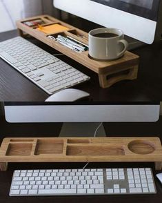 a computer desk with a keyboard, mouse and coffee cup on it's tray