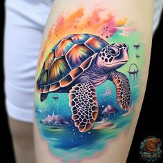 a woman's thigh with a colorful turtle tattoo on the side of her leg