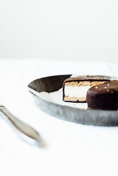 a piece of cake sitting on top of a plate next to a fork and spoon