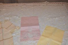 four pieces of cloth laid out on a lace tablecloth