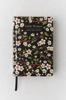 a black notebook with white flowers on it