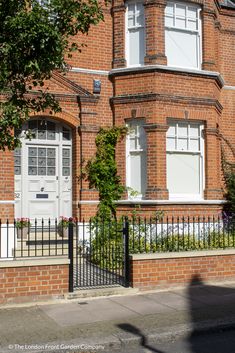 an old brick building with white doors and windows