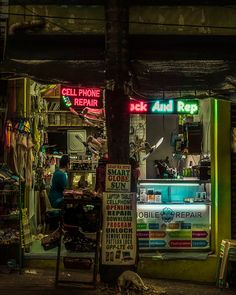 a store front with neon signs on it