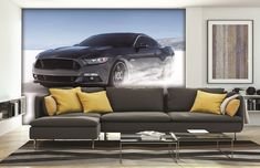 a living room with a couch and a car on the wall in front of it