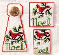 two needled magnets with red birds on them and the words noel spelled in green