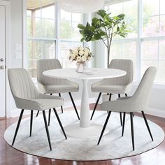 a white table with four chairs around it