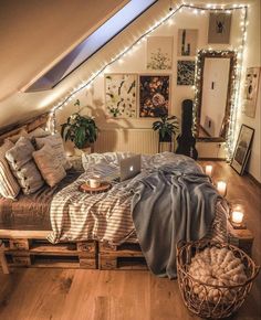 a bed with blankets and pillows in a room filled with lights on the ceiling, surrounded by wooden crates