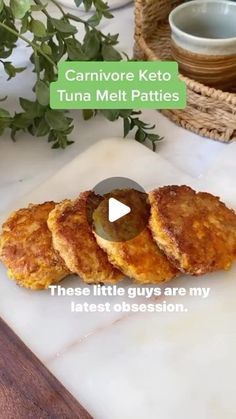 three little guys are on a cutting board next to some plants and a bowl with green leaves