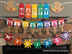 a happy birthday banner hanging from a fireplace