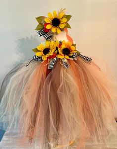 a dress made out of tulle and sunflowers