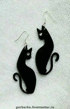 pair of black cat earrings on white background