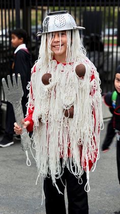 a child dressed in a costume and holding a fork