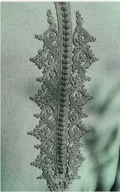 the back of a woman's shirt with an intricate design on it