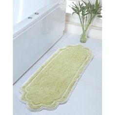 a bath mat sitting on top of a bathroom floor next to a toilet and tub