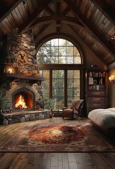 a bedroom with a stone fireplace in the middle and wood flooring on the other side