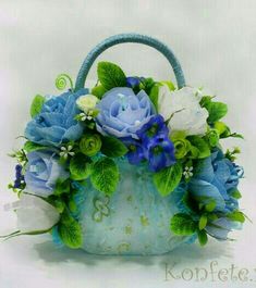 a blue purse with flowers and leaves on it