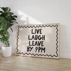 a sign that says live laugh leave by 9pm next to a potted plant