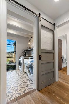 an open door leading to a washer and dryer in a room with wood floors