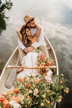 a man and woman in a boat with flowers