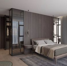 a bedroom with a large bed and glass closets