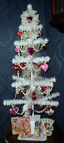 a white christmas tree with hearts on it